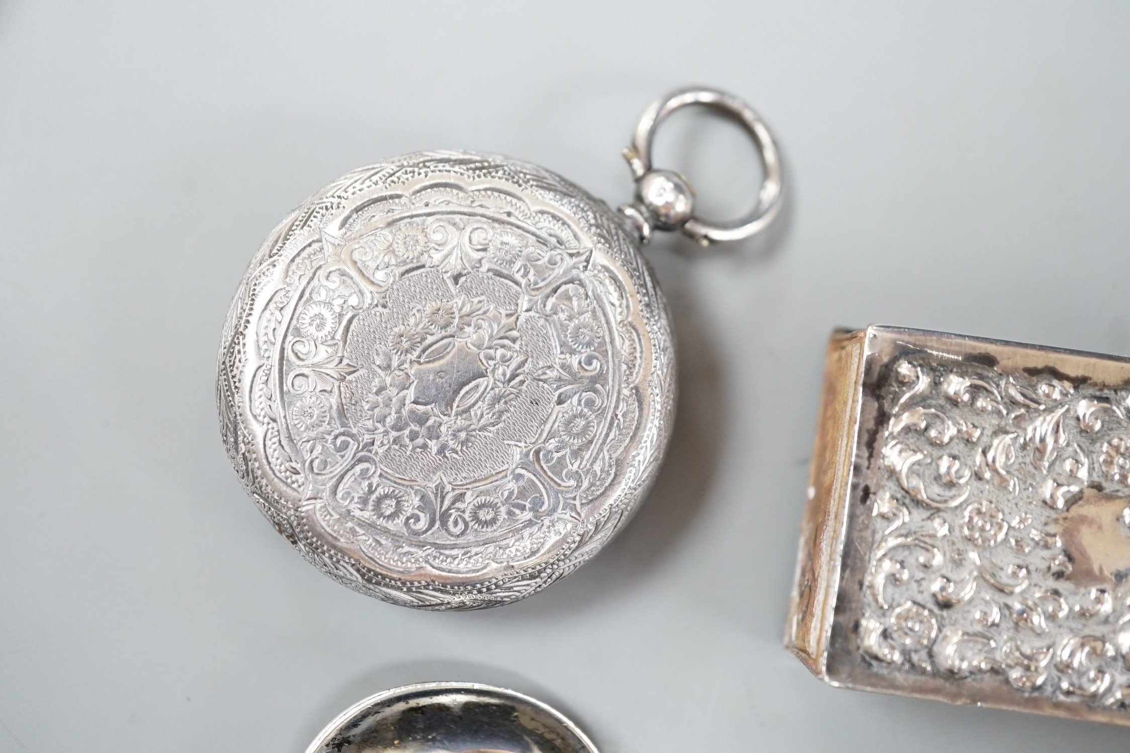 A late Victorian novelty white metal propelling pencil, modelled as a tennis racket, by Sampson Mordan & Co, 64mm, together with a watch case, silver vesta case, spoon and silver matchbox sleeve.